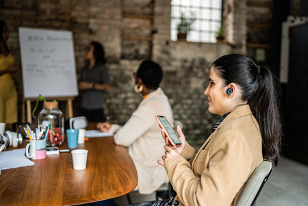 Screenshot of a person working in an office setting.